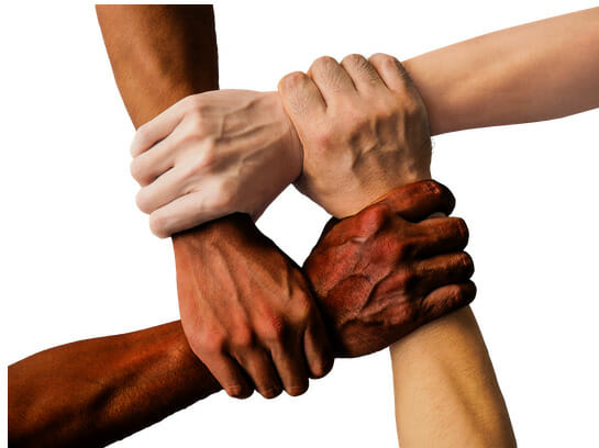 The picture of four hands holding each other, representing how we can empower each other. 