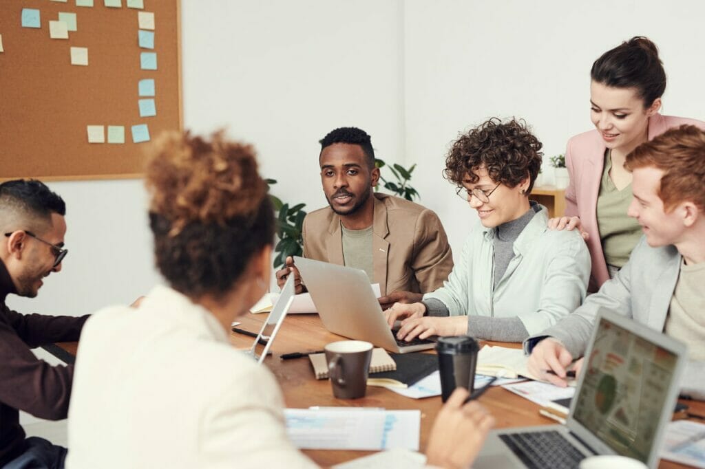 A group of people sharing feedback at the end of a meeting.