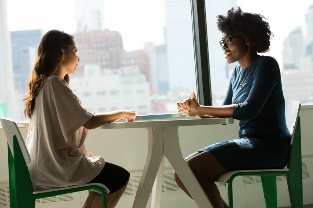 Two people sitting and talking to each other.