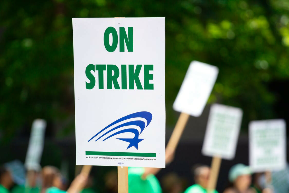 Protestors with "on strike" sign